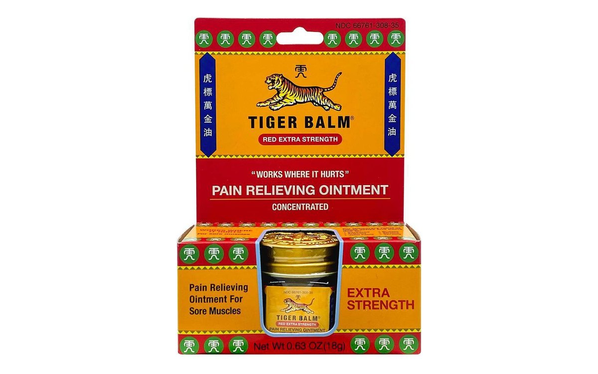 Tiger Balm Red Extra Strength carton on white: red, yellow and green box with a small jar in the front window