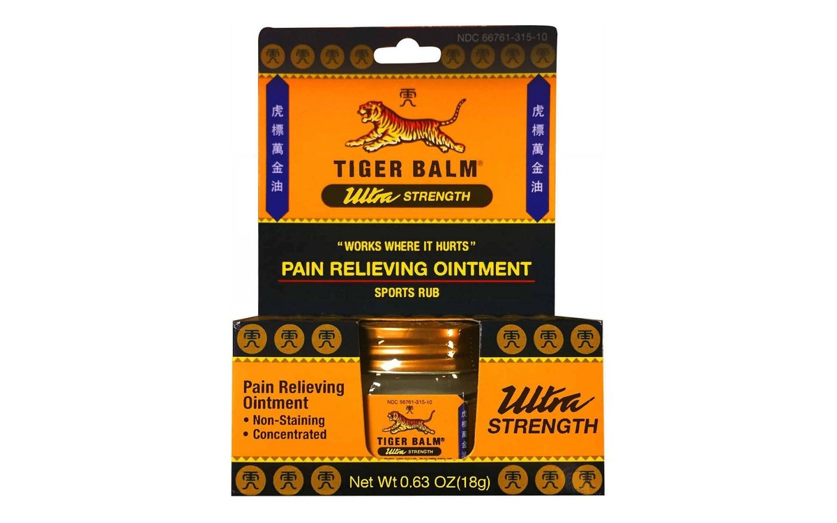 Tiger Balm Ultra Strength carton on white: orange and black box with a small amber jar in the front window