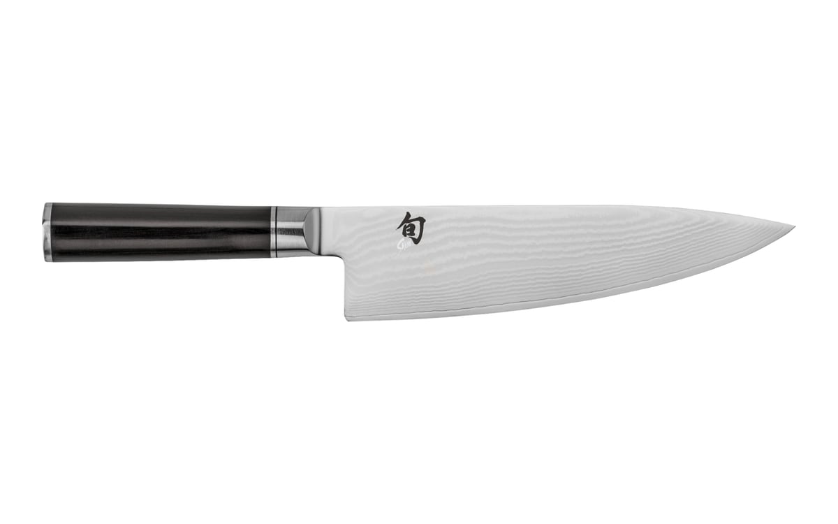 Shun Classic Western cook’s knife on white: a rippled Damascus-pattern blade with the tip to the right and a dark round wooden handle