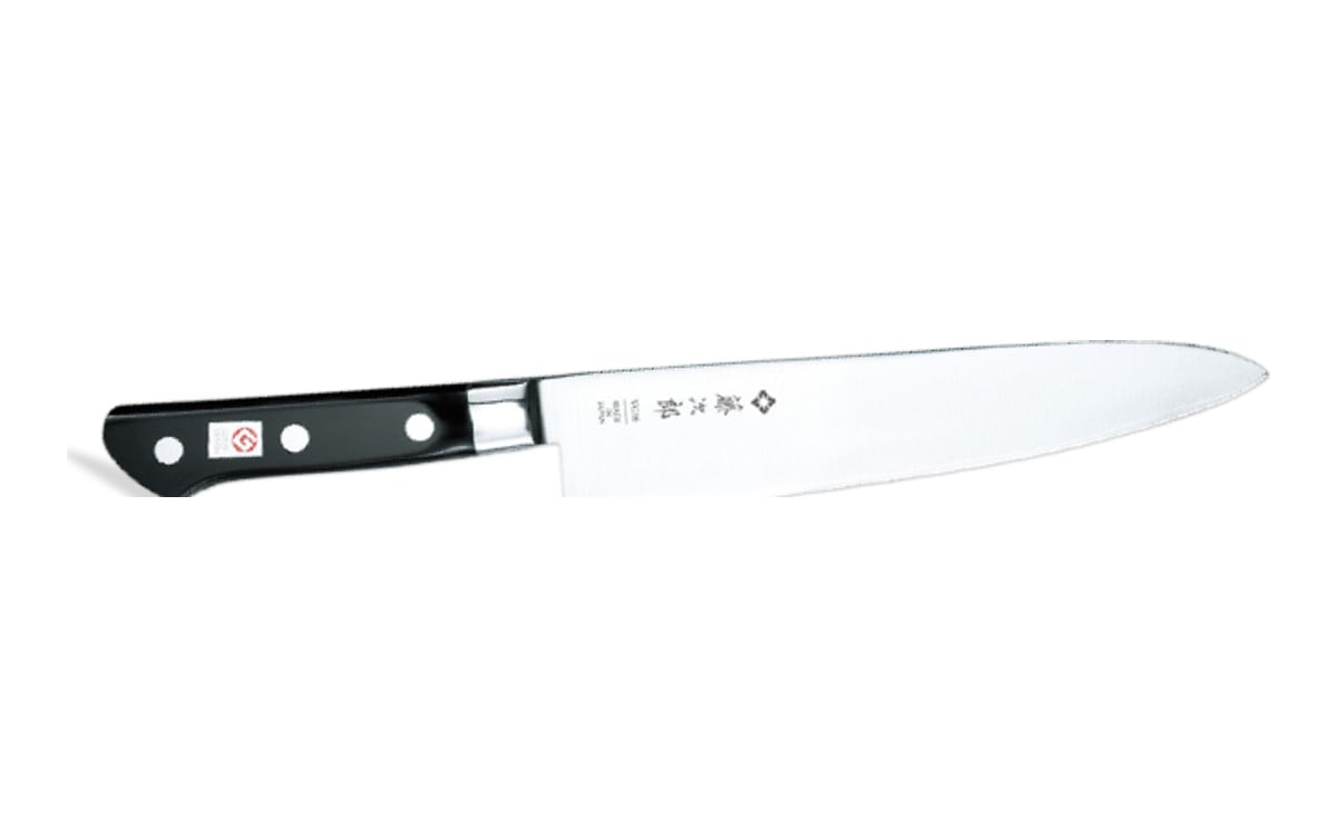 Tojiro F-808 gyuto on white: a long, slim stainless blade with the tip to the right and a black three-rivet handle