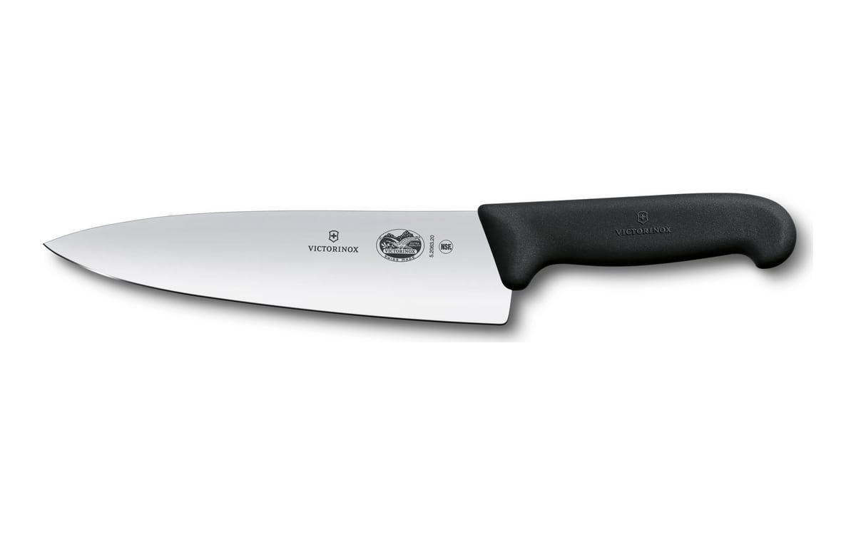 Victorinox Fibrox chef’s knife on white: a wide stainless blade with the tip to the left and a black textured plastic handle