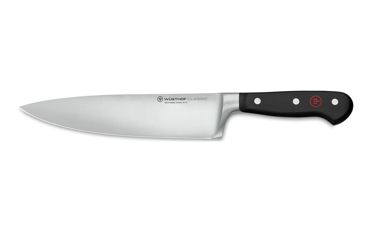 Wüsthof Classic chef’s knife on white: a broad stainless blade with the tip to the left, a full bolster and a black handle with three rivets