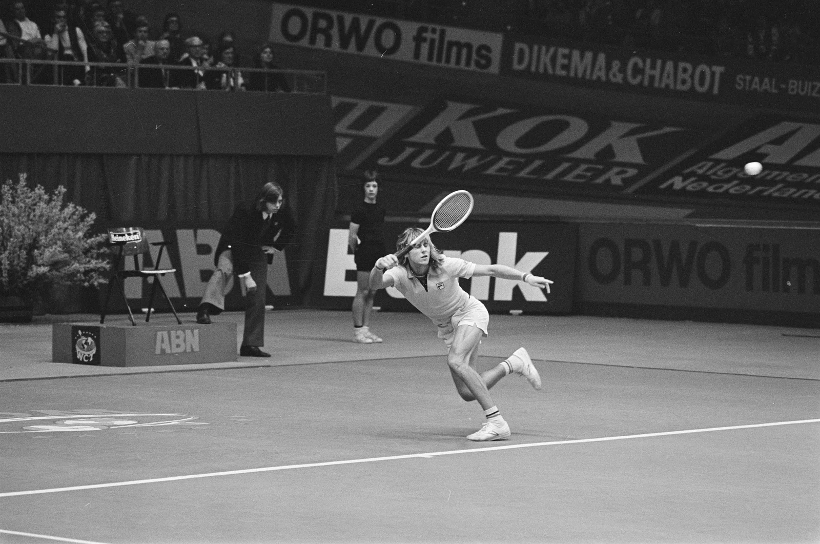 Black-and-white photograph of Björn Borg running toward a tennis ball with his racket raised, wearing a FILA polo.