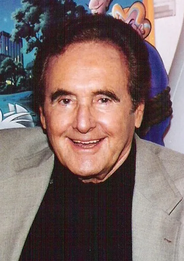 Joseph Barbera smiles in a gray jacket and dark turtleneck.