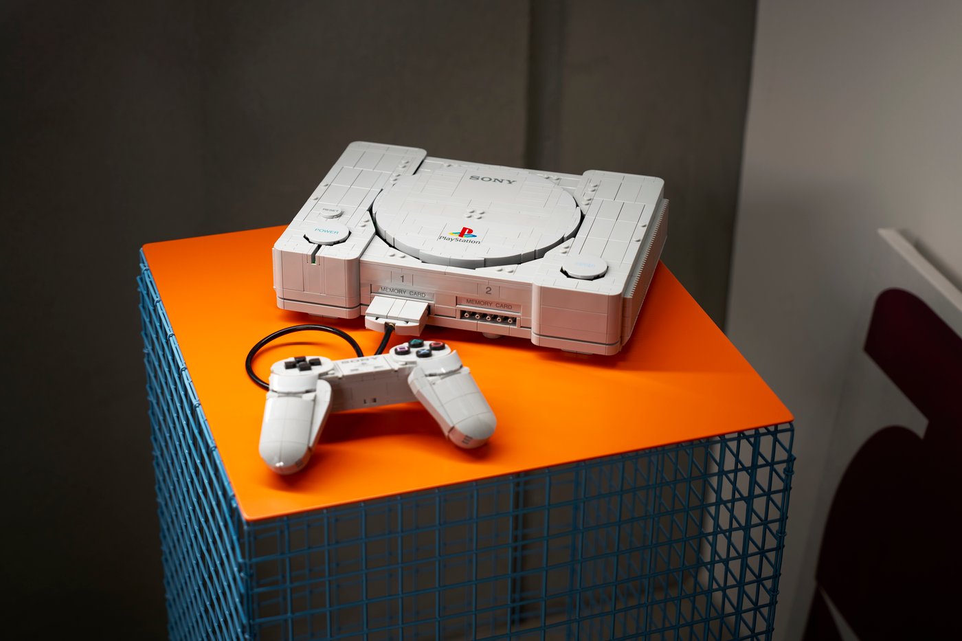 Official LEGO PlayStation lifestyle photograph with the brick-built original console and controller