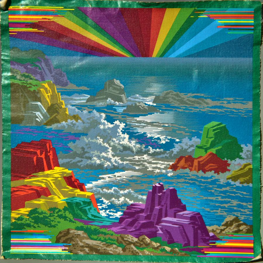 Rainbow burst cliff over churning surf