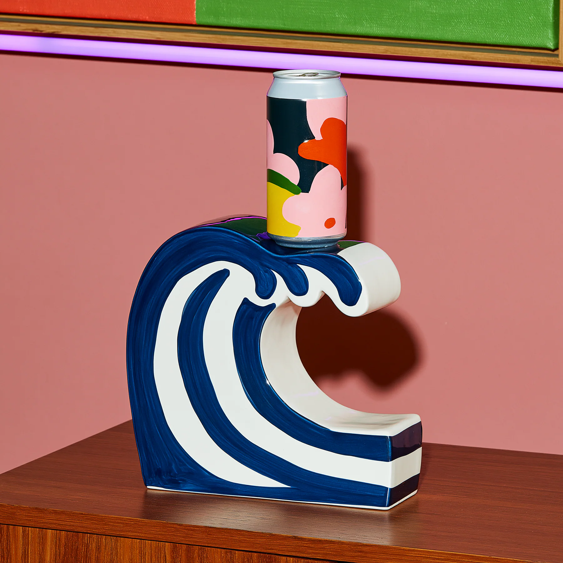A graphic blue wave pedestal on a pink background